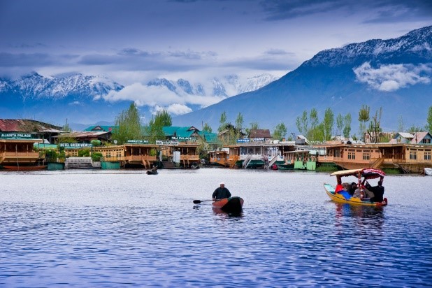 Snow-capped mountains reflecting in a serene Kashmir lake