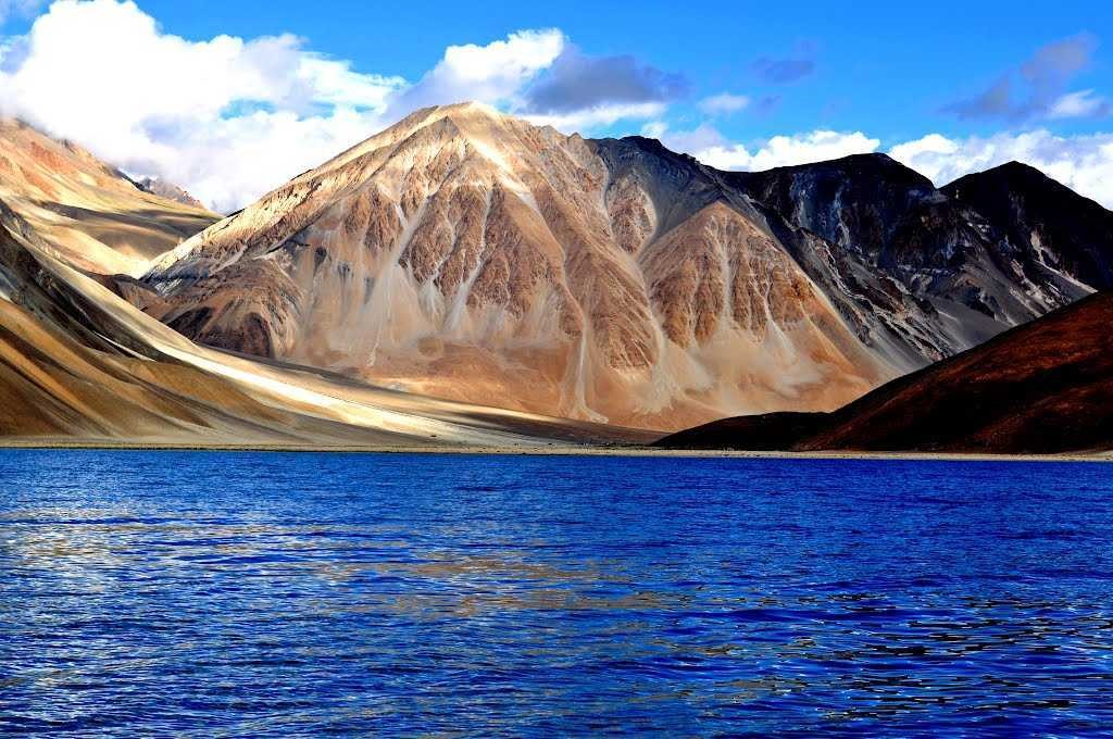 Colorful prayer flags fluttering against a clear Ladakh sky